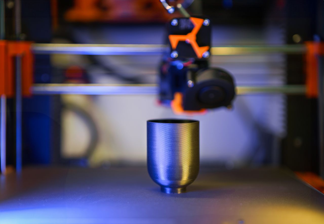 gallery-6 Innovative close-up of 3D printer crafting a metallic object, showcasing modern technology.